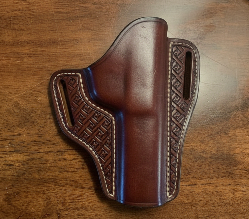 Chestnut leather gun holster with molded body and geometric border tooling – handcrafted custom-order holster